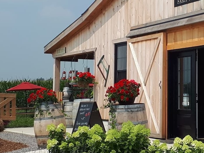 Exterior photo of the Applewood Farm Winery and patio amongst the rolling fields.