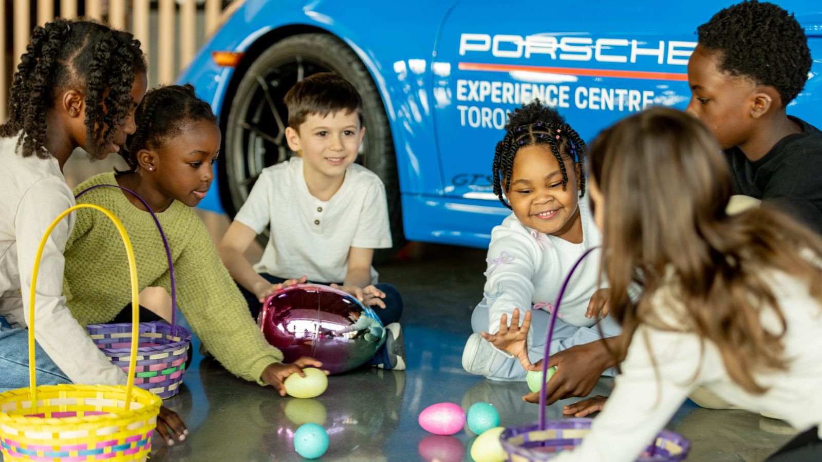 Group of children playing with Easter eggs at Porsche Experience Centre Toronto in Pickering, Ontario