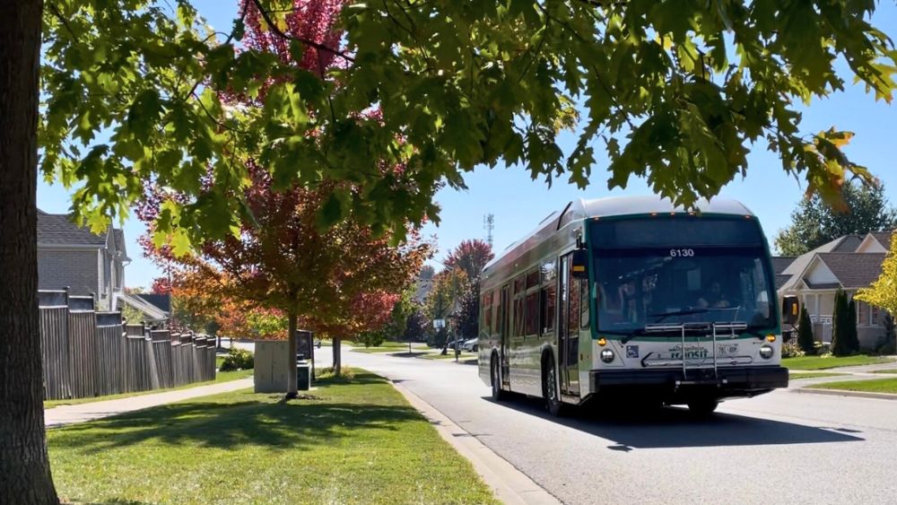 Durham Region Transit (DRT) bus driving on a road in the fall in Durham Region, Ontario, Canada