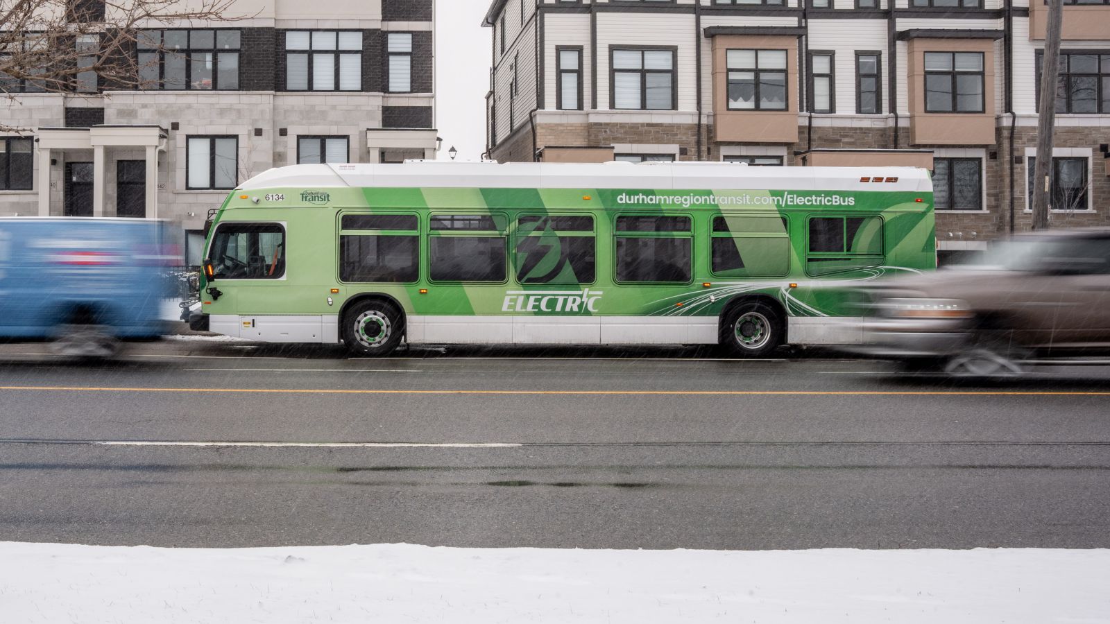 Durham Region Transit (DRT) bus driving on a road in the winter in Durham Region, Ontario, Canada