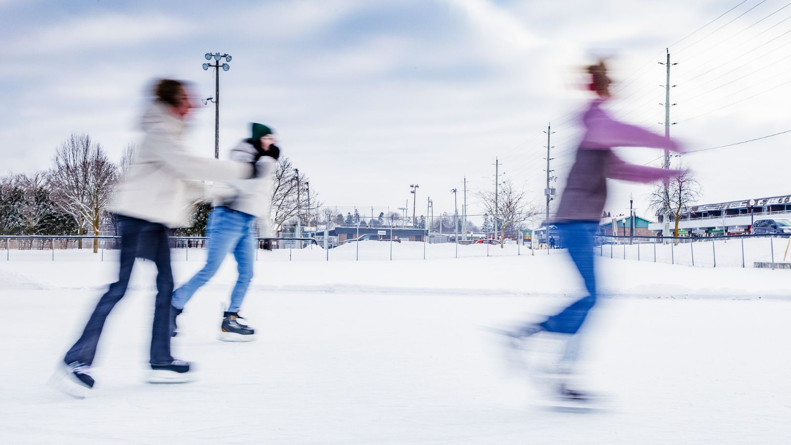 Three people skating at the Lakefront Skate & Market in Port Perry, Ontario