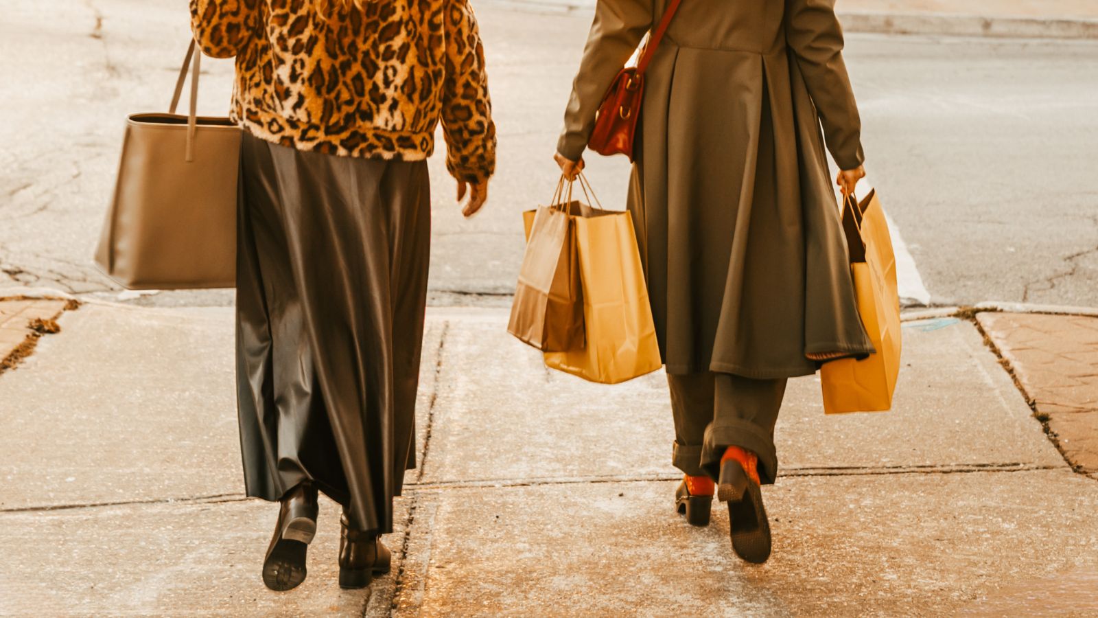 Two people walking with shopping bags in downtown Port Perry, Ontario