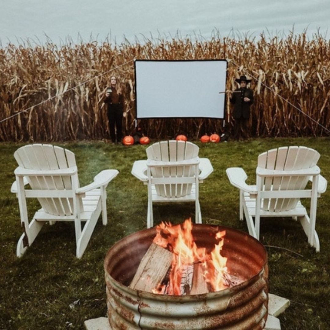 Lawn chairs and a projector screen in front of a corn field at Two Blokes Cider in Seagrave, Ontario, Canada