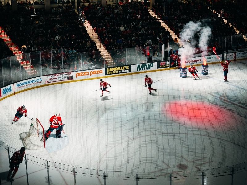 Image of Oshawa Generals hockey game where the players are skating on the ice while the crowd cheers