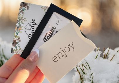 Hand holding gift cards to local businesses in Durham Region, Ontario, Canada