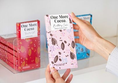 Hand holding a chocolate bar from One More Cocoa in Whitby, Ontario