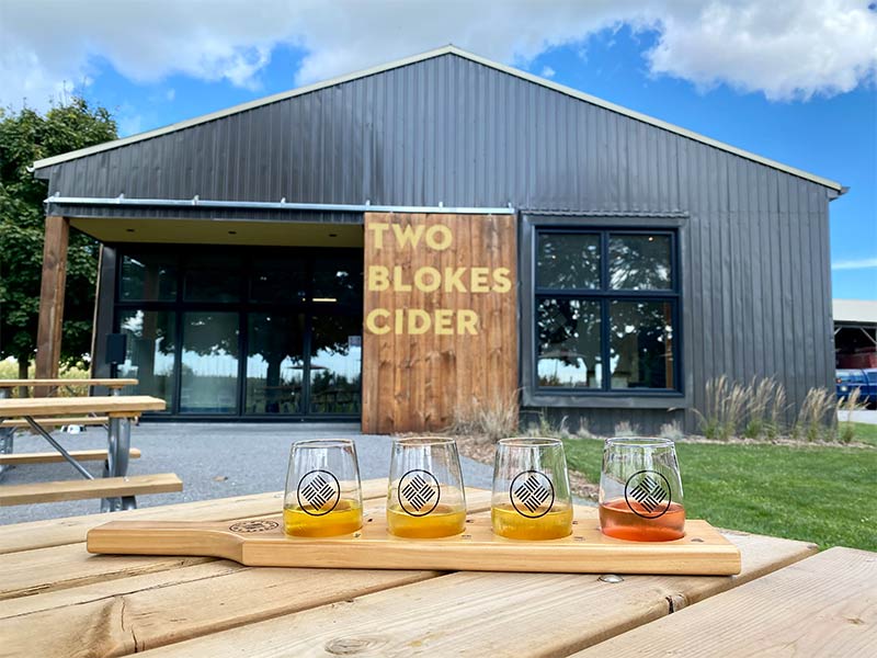 A photo of Two Blokes Cider exterior with a flight of cider in front