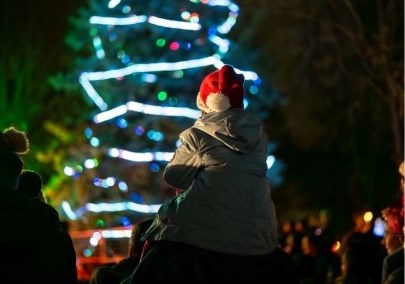 Child on their parents shoulder in a crowd of people at a holiday event in Durham Region, Ontario, Canada