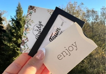 Hand holding gift cards to local businesses in Durham Region, Ontario, Canada