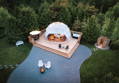 Aerial image of a dome shaped tent and a deck with hot tub