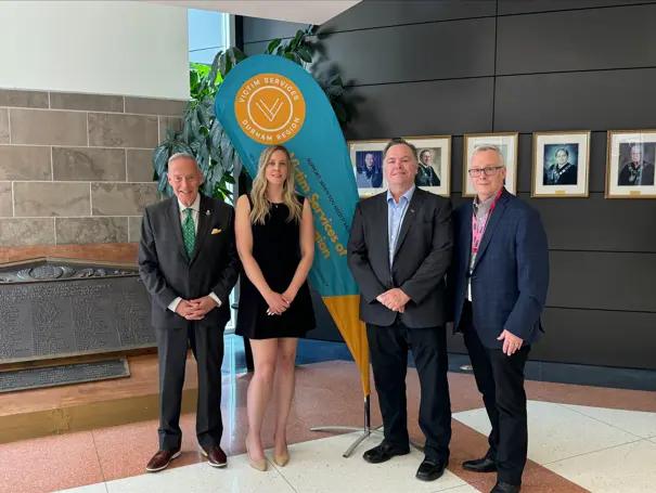 MPP for Whitby, Lorne Coe; Regional Chair and CEO, John Henry, and representatives from Victim Services of Durham Region at a funding announcement for expanded outreached for gender-based violence.