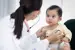 Baby getting a check-up by a health care provider. 