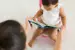 Child reading on a potty. 