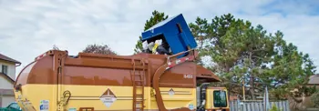 Garbage-truck-picking-up-waste-at-private-property.jpg