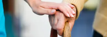 Woman's hand on elderly male's hand