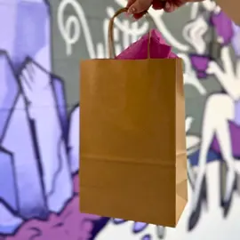 Hand holding a shopping bag at Markets Ontario in historic downtown Bowmanville, Ontario 