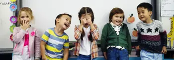 A diverse group of children laughing together