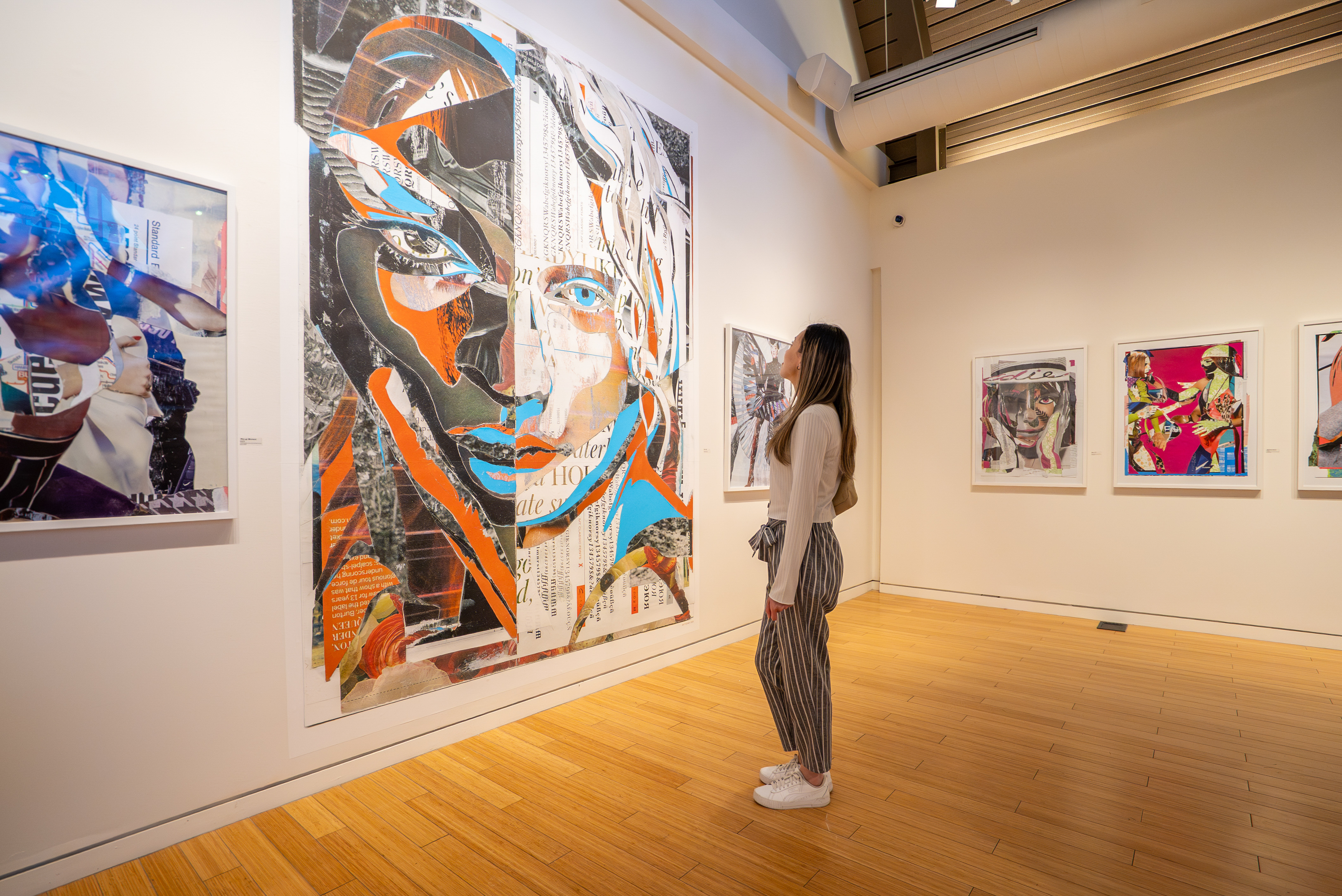 Woman standing in front of brightly coloured painted art work