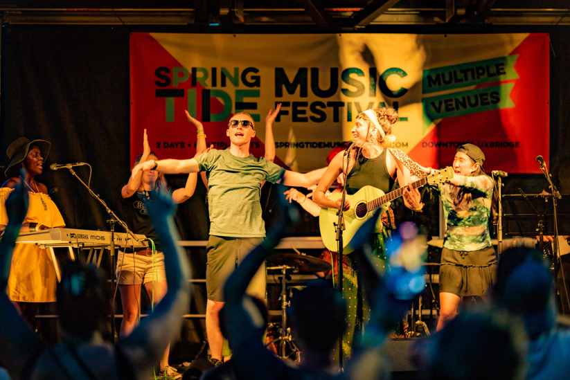 Band on stage at Springtide Music Festival.
