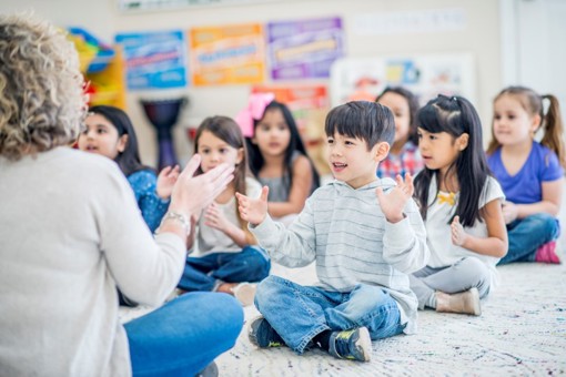 Teacher with children in a classroom activity