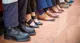 Employees feet in focus as they sit on a bench