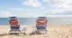 two beach chairs by the water