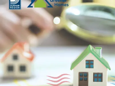 A miniature home appears in the foreground with another home behind it and a hand holding a magnifying glass. The Durham Region logo and Durham Greener Homes logo appear in the top corner.