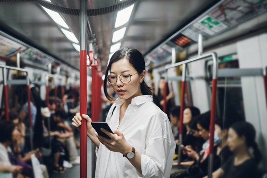 Person using a phone on public transit