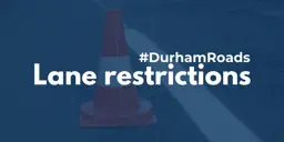 A pylon on a road, with a dark blue filter over top and white text that reads #DurhamRoads Lane restrictions