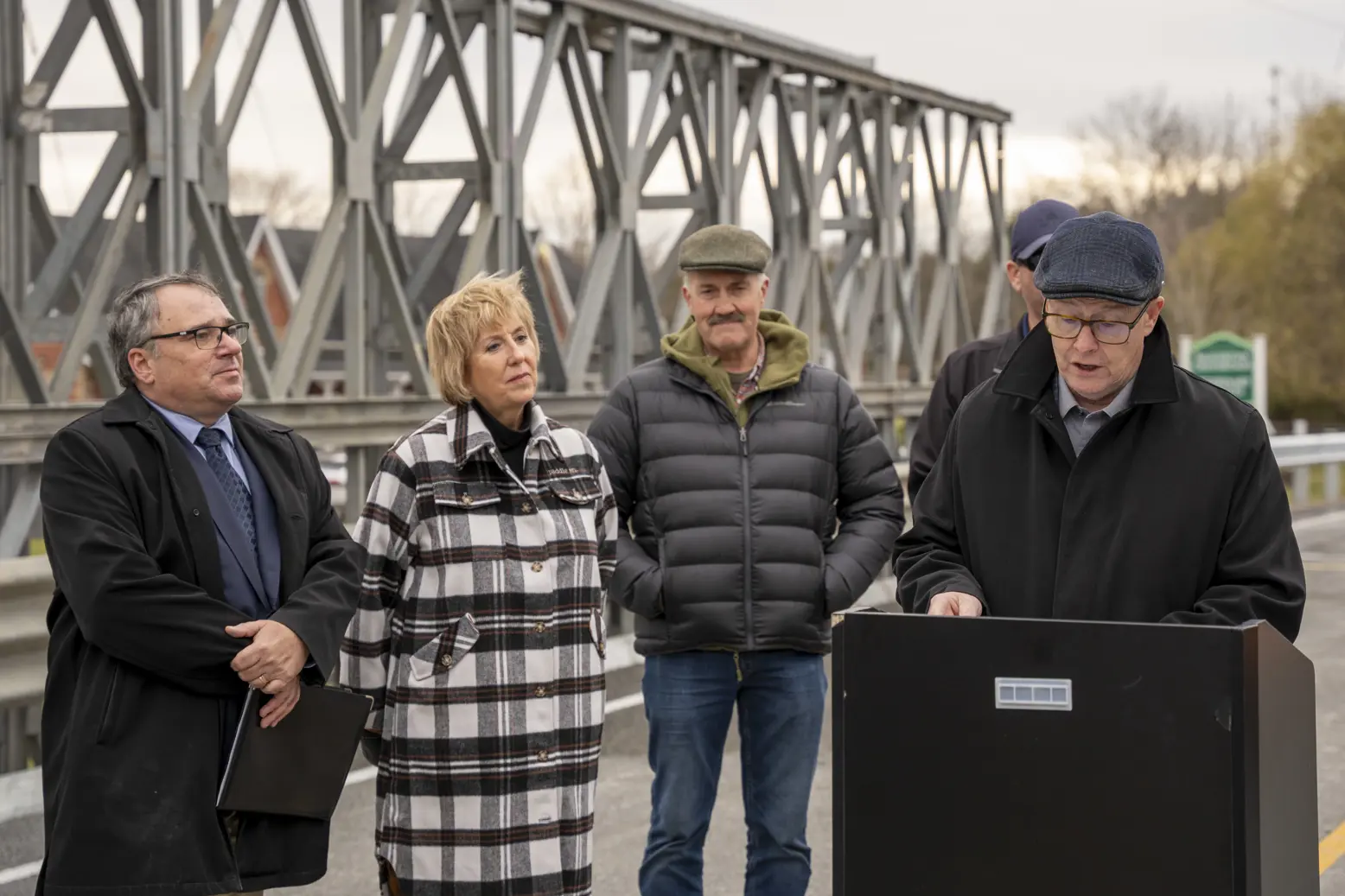Regional Chair and CEO, John Henry, speaking at a podium on the new temporary Beaver River Bridge in Beaverton