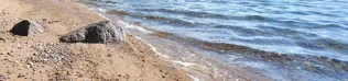 Sandy beach at a lake.