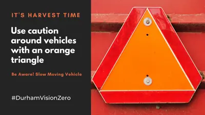 Farm-vehicles-on-Durham-roads-orange-triangle-emblem.png