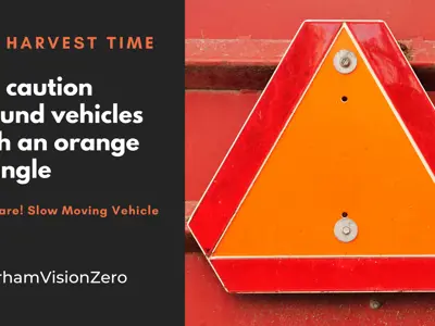 Farm-vehicles-on-Durham-roads-orange-triangle-emblem.png